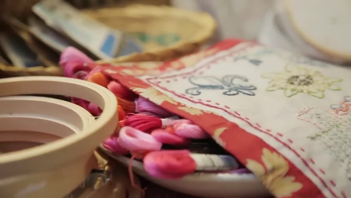 Meng describing bead, weaving, embroidery, and papercraft workshops
