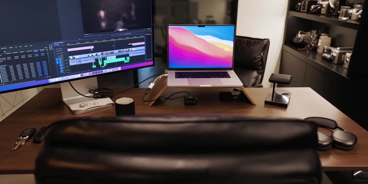 Peter McKinnon pointing toward back of studio space