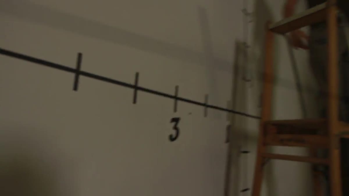 Grid taped on wall with softbox positioned six feet away