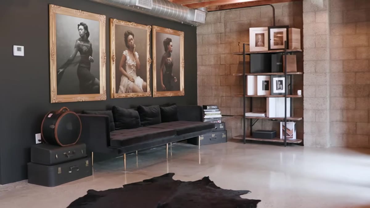 caption: Three large portrait prints displayed in the studio entrance