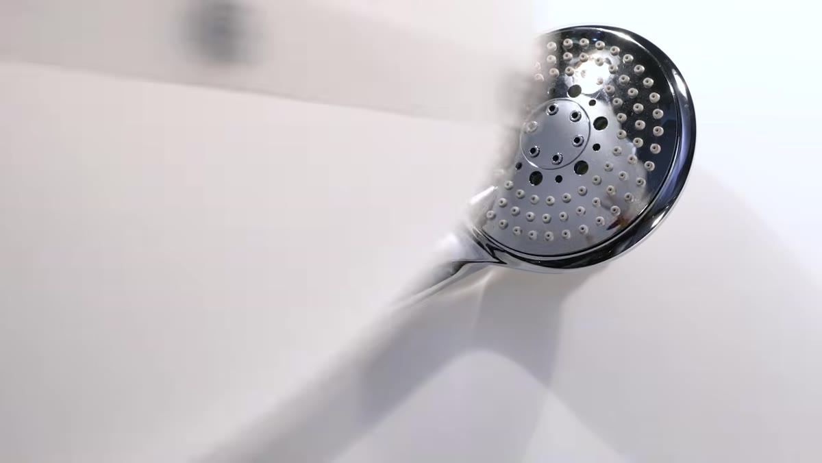 Before and after comparison: chrome shower head with and without light cone