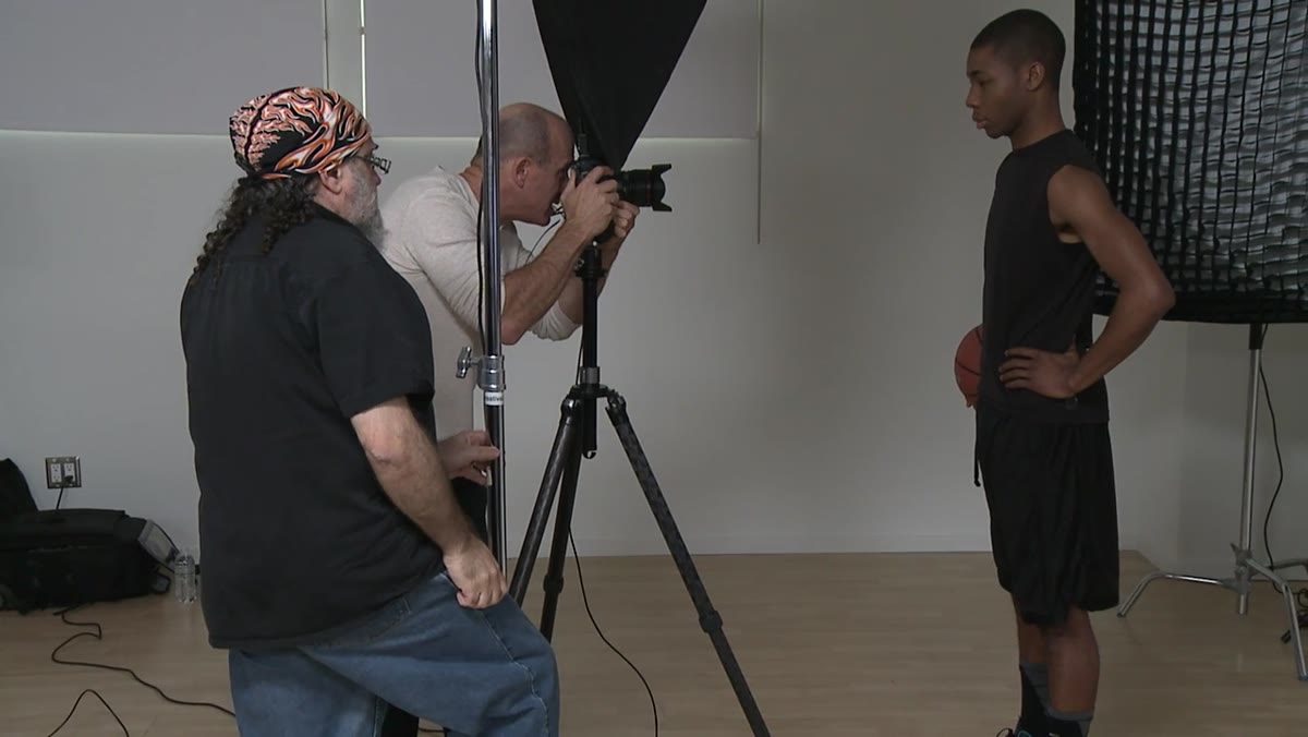 Reviewing the final frame on a monitor showing refined facial contrast